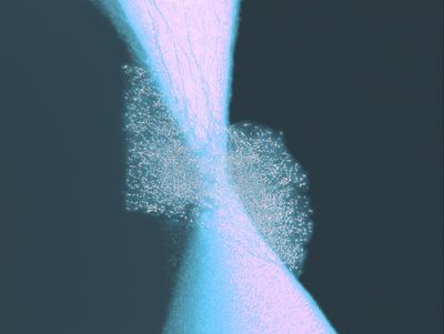 Abstract glowing pink and cyan hourglass form pinching at a bright center, flanked by speckled clouds on a dark teal background.