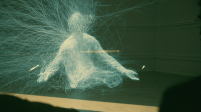From a low angle, a seated blue-white wireframe figure with a head of dense, unreadable text; thousands of fine filaments erupt from its back and head like a neural aurora across a dim green room. A faint amber line crosses the chest.
