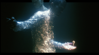 A close, shimmering figure made of sparkling text-particles: one arm reaches left toward a thin bright blade of light, while the other hand opens palm-up at lower right, cupping a small glowing amber question mark.