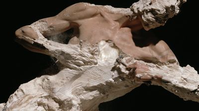 A reclining marble torso, smooth flesh fading into rough stone, a glowing translucent alabaster mass where the heart would be.