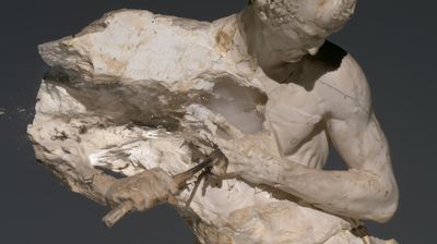 A marble figure drives chisel and mallet into its own chest, opening it onto a smoky, semi-transparent crystalline core.