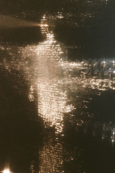 A profile face of amber script crowned by a star flare of light, a formation of chrome androids standing at attention below.
