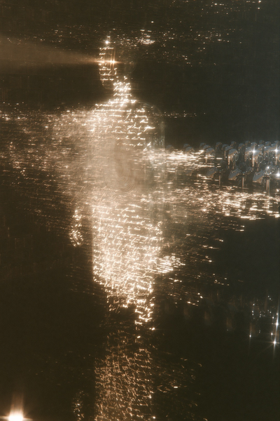 A profile face of amber script crowned by a star flare of light, a formation of chrome androids standing at attention below.