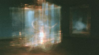 A large translucent blue lantern glows amber at its base, with a dim window floating to its right.