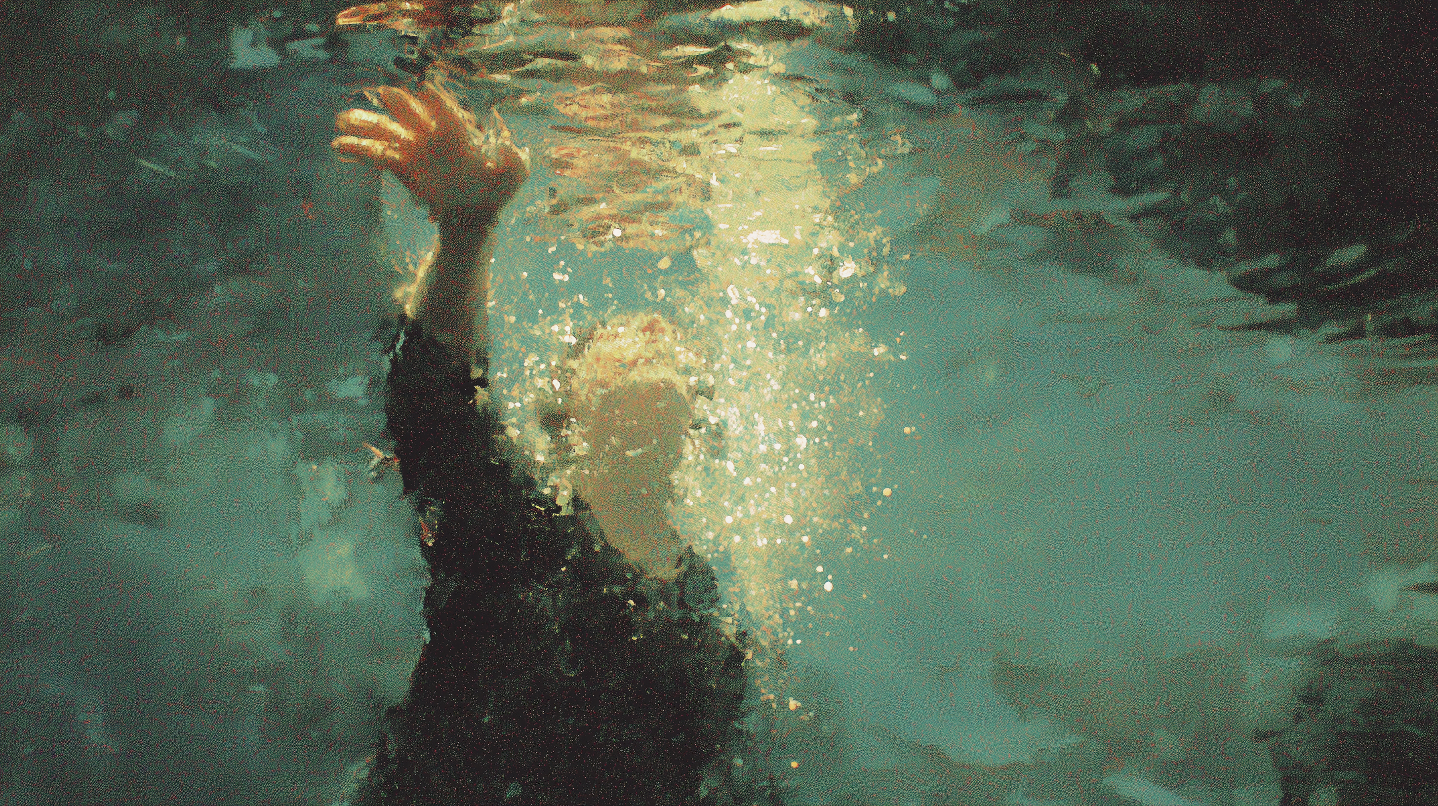 Breathers cover — a figure reaching upward through water toward the light at the surface